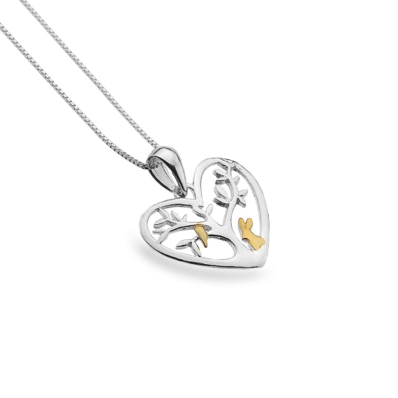 silver and gold plated detail rabbit stood by a tree in a heart pendant