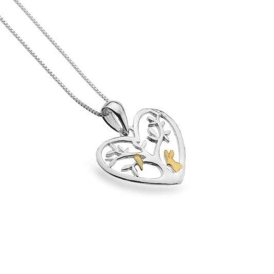 silver and gold plated detail rabbit stood by a tree in a heart pendant