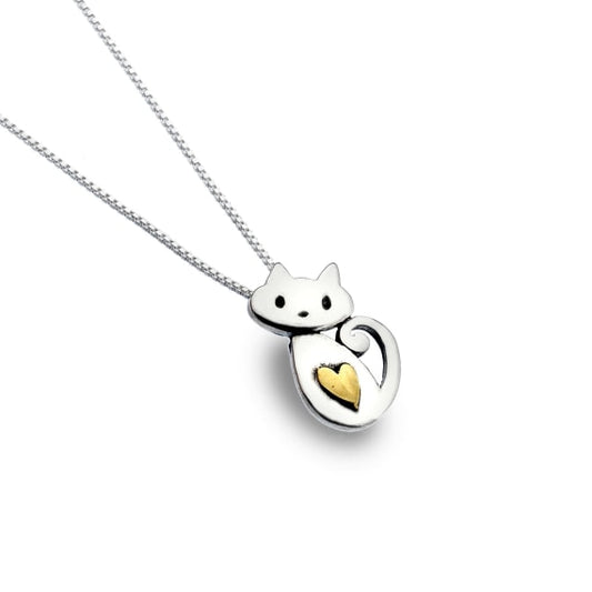 silver and brass cat with a heart pendant